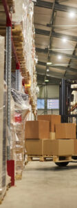 Background image of warehouse interior with forklift carrying boxes, copy space